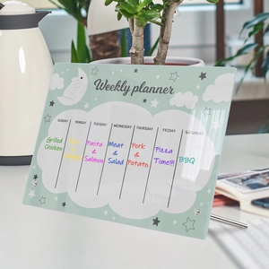 Macro shot of mint green acrylic weekly planner with cute bear and metal stand