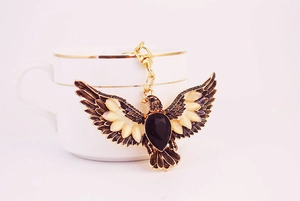 Close-up of vintage eagle keychain with black rhinestone and golden metal details
