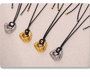 Modern twisted geometric pendants in gold and silver finish with black leather cords