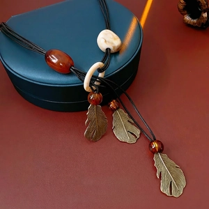 Bohemian leaf pendant necklace with resin beads and bronze feather charms on black cord