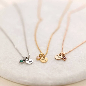 Custom titanium steel heart necklaces with birthstones in silver, gold, and rose gold finishes