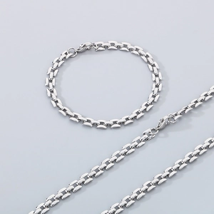 Macro detail of silver-tone hollow rectangular link necklace and bracelet jewelry set