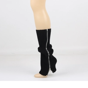 Detail of black knitted leg warmer featuring a functional silver zipper on the side
