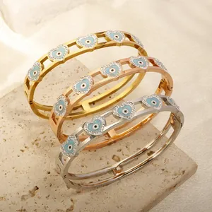 Detailed view of heart-shaped evil eye bracelets in gold, rose gold and silver finishes
