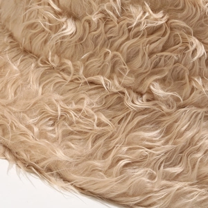 Close-up of soft khaki faux fur texture with long fluffy plush fibers on a bucket hat