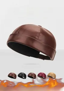 Close-up of PU leather brimless dockers hat showing multiple color options and texture