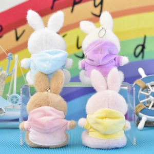 Back view of four adorable plush bunny keychains wearing colorful hoodies on display