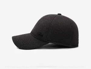 Side view of dark gray woolen winter baseball cap with metal logo detail and thick fabric