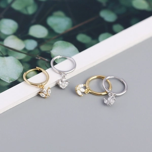 Detail view of s925 silver gold and silver hoop earrings with marquise zircon charms