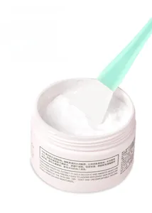 Detail of soft silicone facial mask brush paired with moisturizing sheep oil cream jar