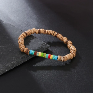 Detailed view of handmade beaded bracelet with coconut shells and natural stones on stone