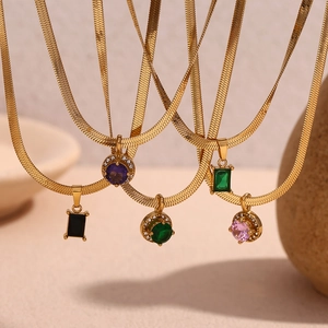 Detailed view of 18K gold snake chain necklaces with colorful square and round pendants