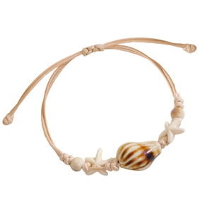 Detail of adjustable ocean-themed woven bracelet with striped conch and white starfish