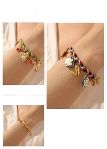 Detail showing hand-woven colored rope bracelets with gold-plated charms and pearls
