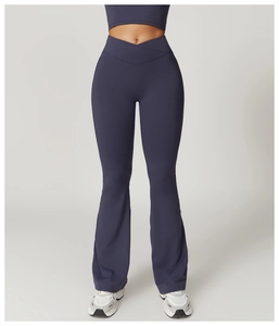 Detail of high-waisted crossover waistband on flared yoga pants in dark grey blue