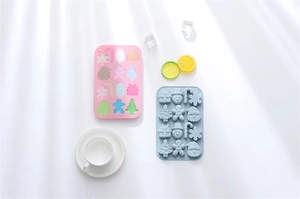 Detailed view of pink and blue silicone molds featuring festive Christmas shapes