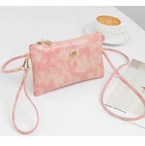 Elegant pink bamboo textured crossbody bag featuring sparkling rhinestone hardware detail.