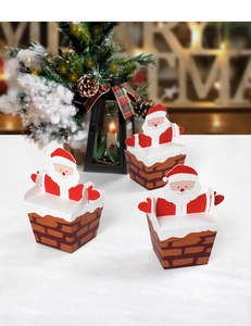 Detailed view of three Santa Claus chimney gift boxes on a marble table with holiday decor