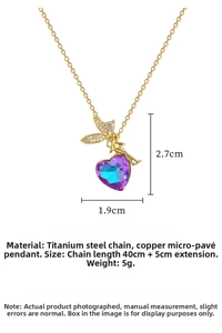 Detail view of heart pendant with purple gradient crystals and fairy wings on gold chain