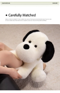 Dettaglio del peluche cane bianco e nero con pelliccia morbida e simpatiche orecchie lunghe