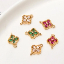 Macro shot of colorful zircon clover connectors with double loops for DIY jewelry making