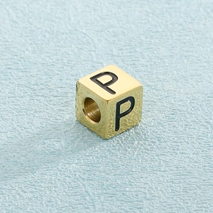 Macro shot of gold cube letter bead P for DIY stainless steel bracelet making
