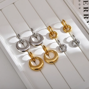 Detail of detachable double hoop earrings in gold and silver finish on display