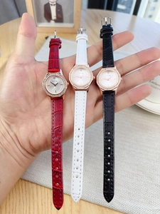 Close-up of three quartz watches with leather crocodile straps and diamond-encrusted bezels