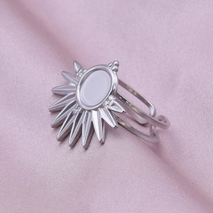 Detail of adjustable silver stainless steel ring with a sunburst starburst design