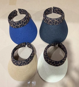 Detail view of woven sun visors with leopard print elastic bands in four stylish colors