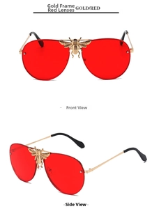 Detail of pilot sunglasses with red lenses, gold frames and bee bridge embellishment