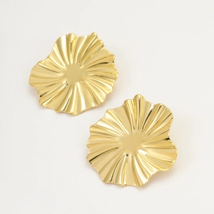 Macro detail of gold wavy irregular disc earrings with high-polished mirror finish