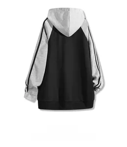 Back view of a loose-fit color-block hoodie featuring grey sleeves with black stripes