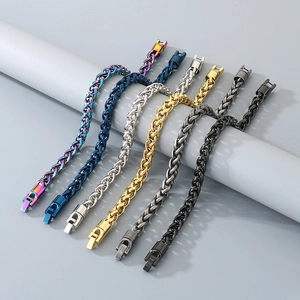 Detail showing various colors of stainless steel woven chain bracelets on display stand
