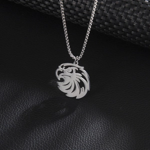 Polished silver stainless steel lion head pendant necklace on textured background