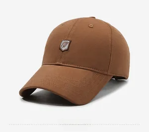 Detailed side view of dark brown cotton baseball cap showing stitching and shield logo