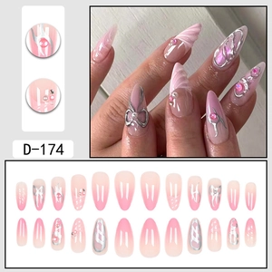 Pink and white gradient press-on nails with 3D bows, silver embossing and pearl accents