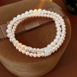 Close-up of double-layer pink pearl bracelet with a sparkling crystal encrusted clasp