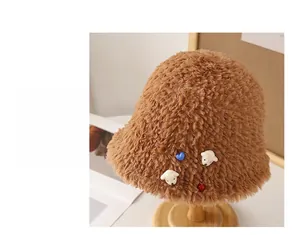Detail of caramel plush bucket hat with cute 3D bear and heart charms for winter