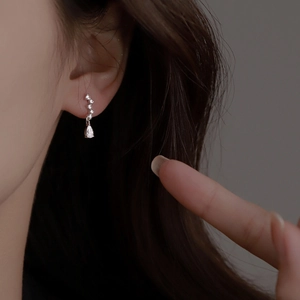 Elegant silver tassel earrings with zircon water drop pendants worn by a model