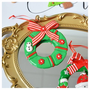 Detail of Christmas wreath ornament with bow and snowman on vintage gold mirror