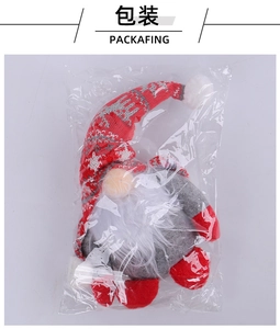 Detail view of a plush Christmas gnome ornament packaged in a protective clear plastic bag