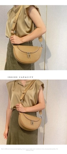 Detail view of khaki half-moon crossbody bag with litchi grain texture and wide strap