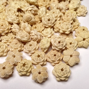 Handcrafted boxwood lotus flower beads in cream white with intricate carved details