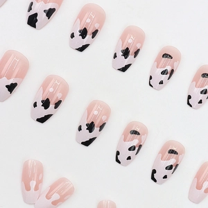 Chic coffin ballerina false nails with nude base, white milk splash and cow print pattern