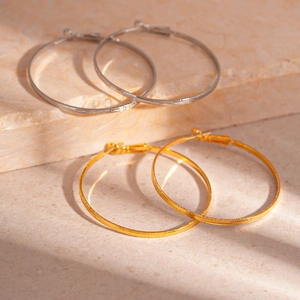 Chic geometric metal hoop earrings in gold and silver finish with brushed texture