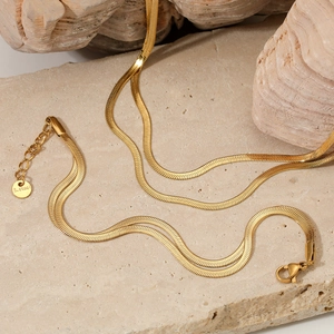 Detailed macro view of the gold-plated stainless steel flat snake chain and lobster clasp