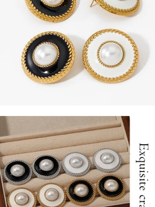Detail of vintage round enamel earrings with pearl center and textured metal borders