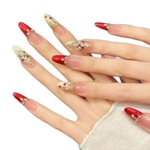 Handmade Christmas press-on nails with red glitter, heart rhinestones and pearl trees