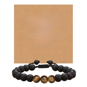 Detailed view of adjustable black onyx and tiger eye bead bracelet with a gift card